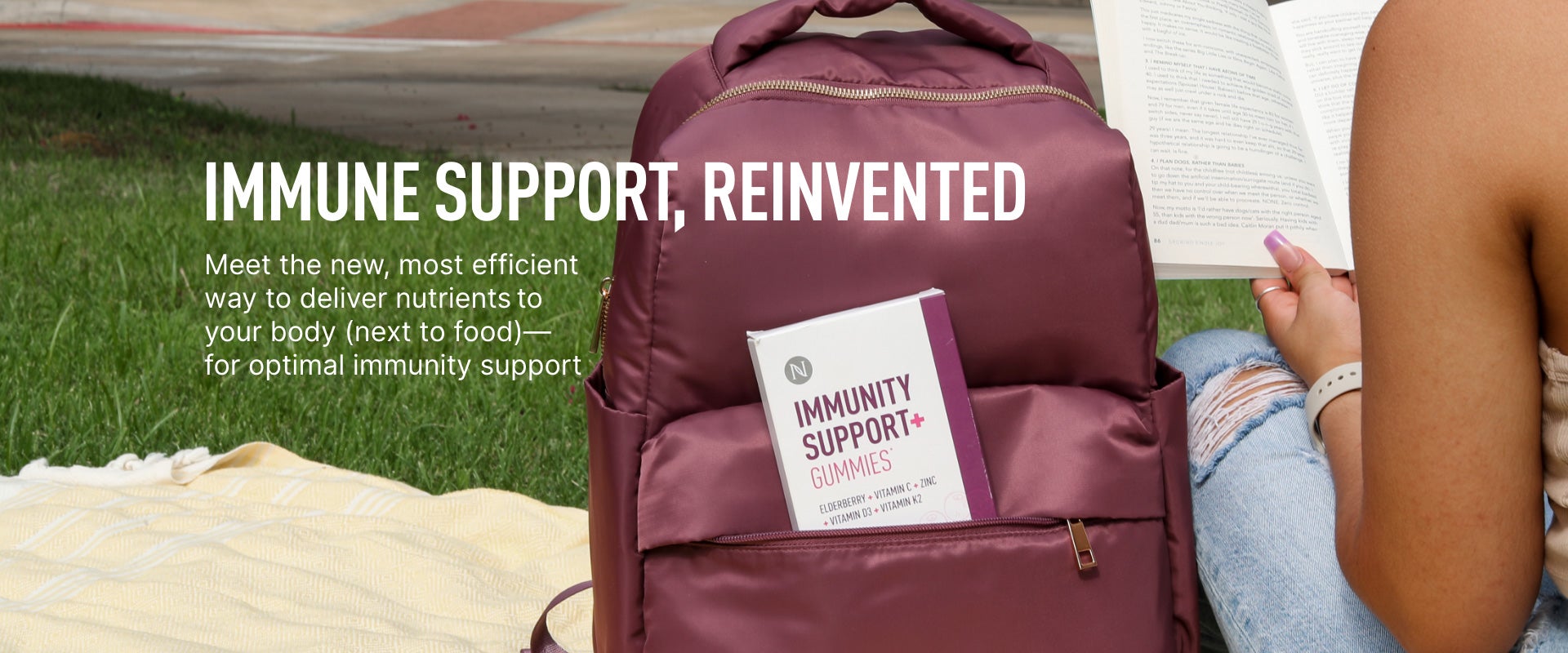 Neora’s NEW Immunity Support+ Gummies in a backpack with a woman sitting next to it reading a book.